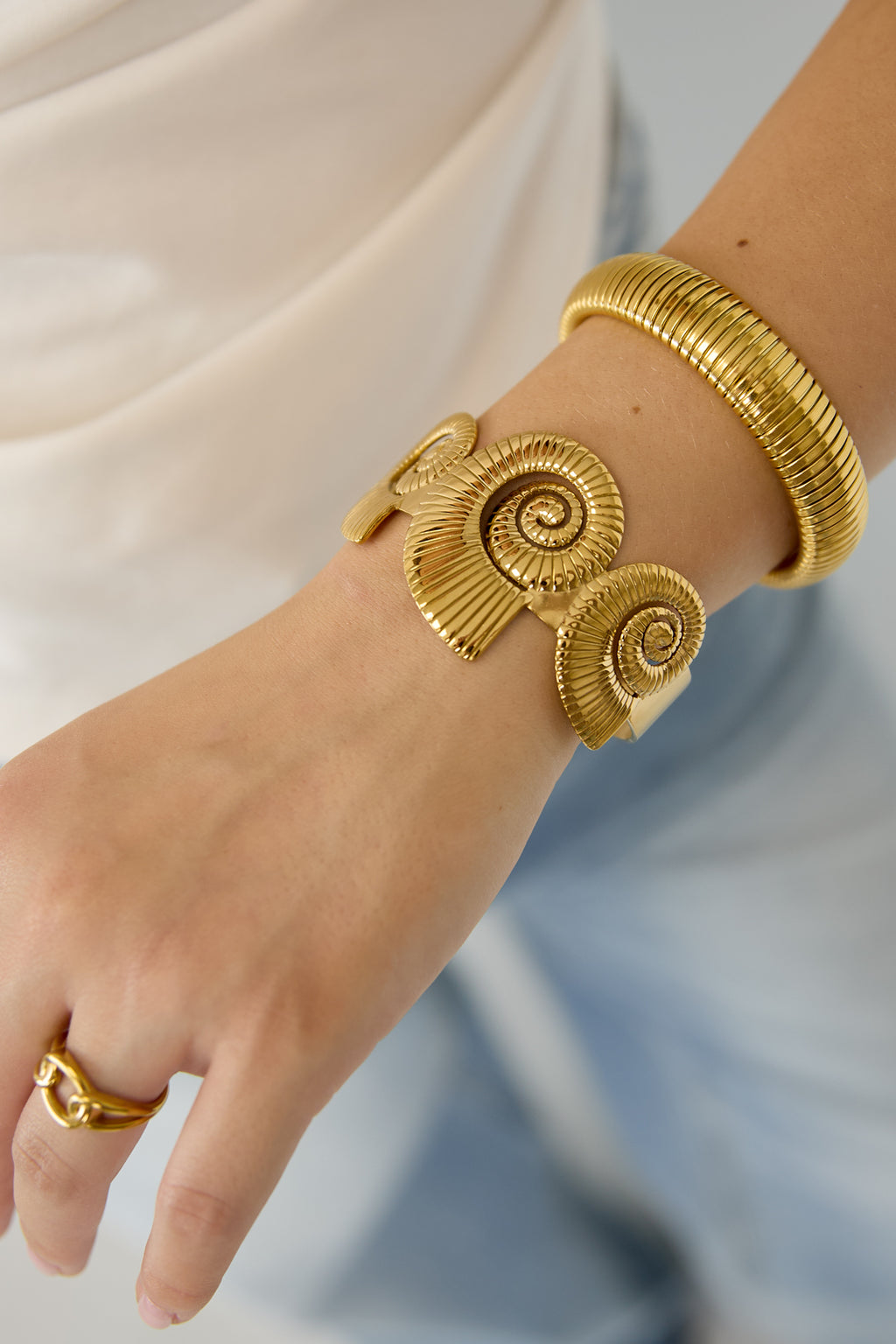 Cuff statement bracelet with spiral shells